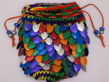 Load image into Gallery viewer, Dragon scale dice bag knitted with red, orange, green, blue, purple, and silver metallic scales made from rainbow colored yarn.
